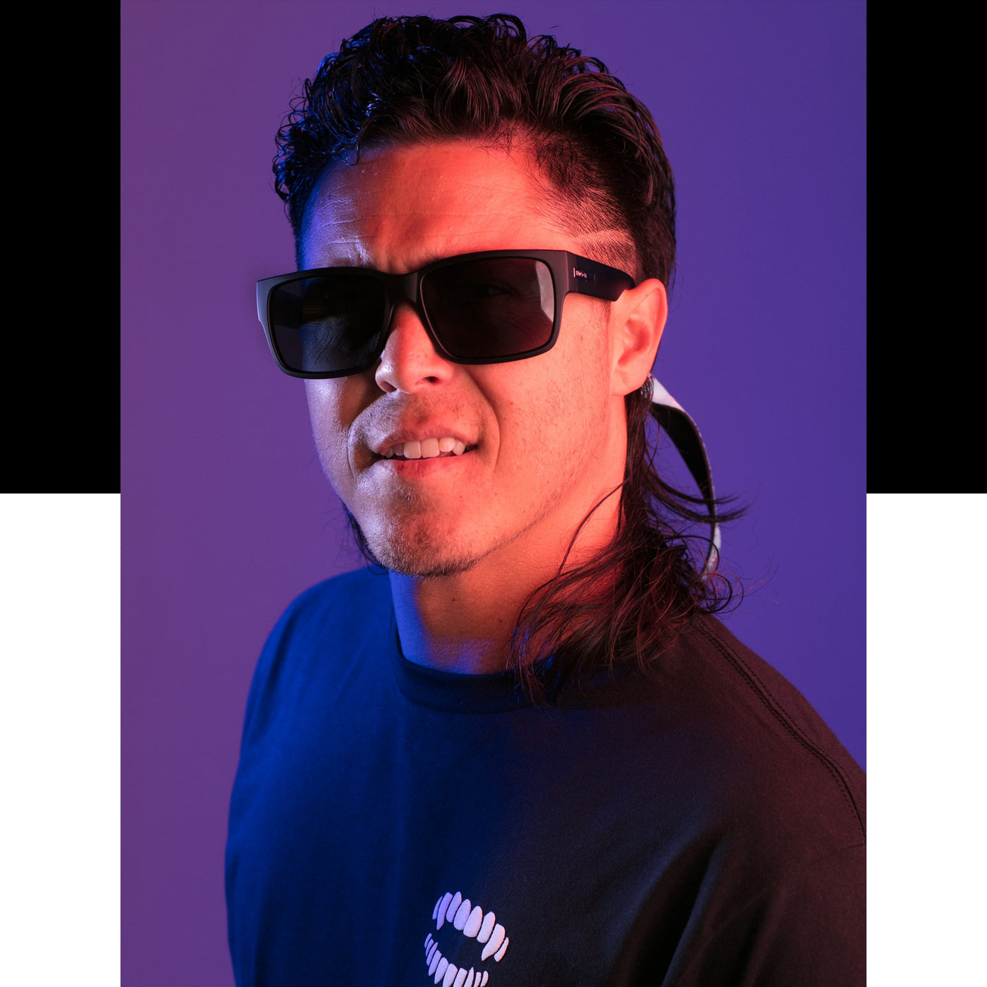 Man with a mullet wearing oversized black shades