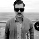 Man at the beach with retro black sunglasses