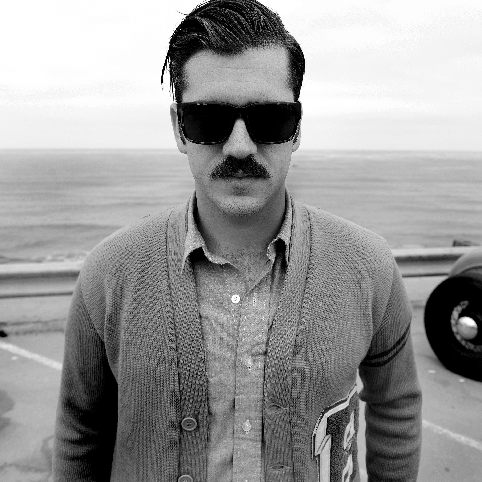 Man at the beach with retro black sunglasses